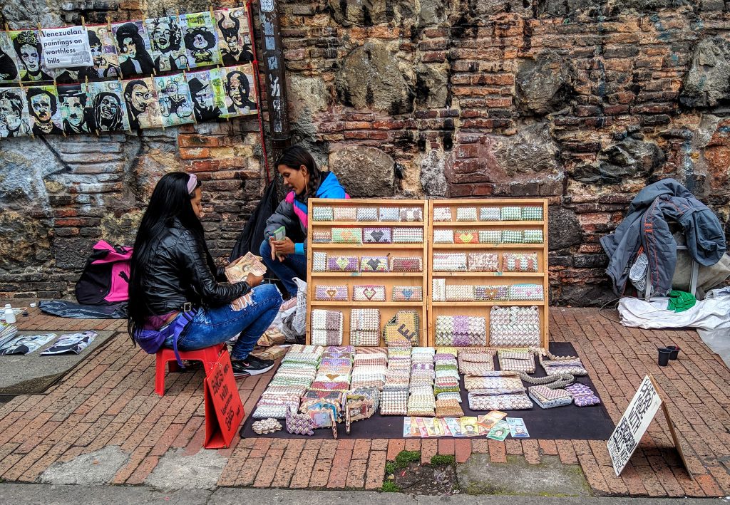 Venezuelan Refugees in Bogotá Selling Crafts Made of Worthless Venezuelan Cash. Source: Wikimedia Commons