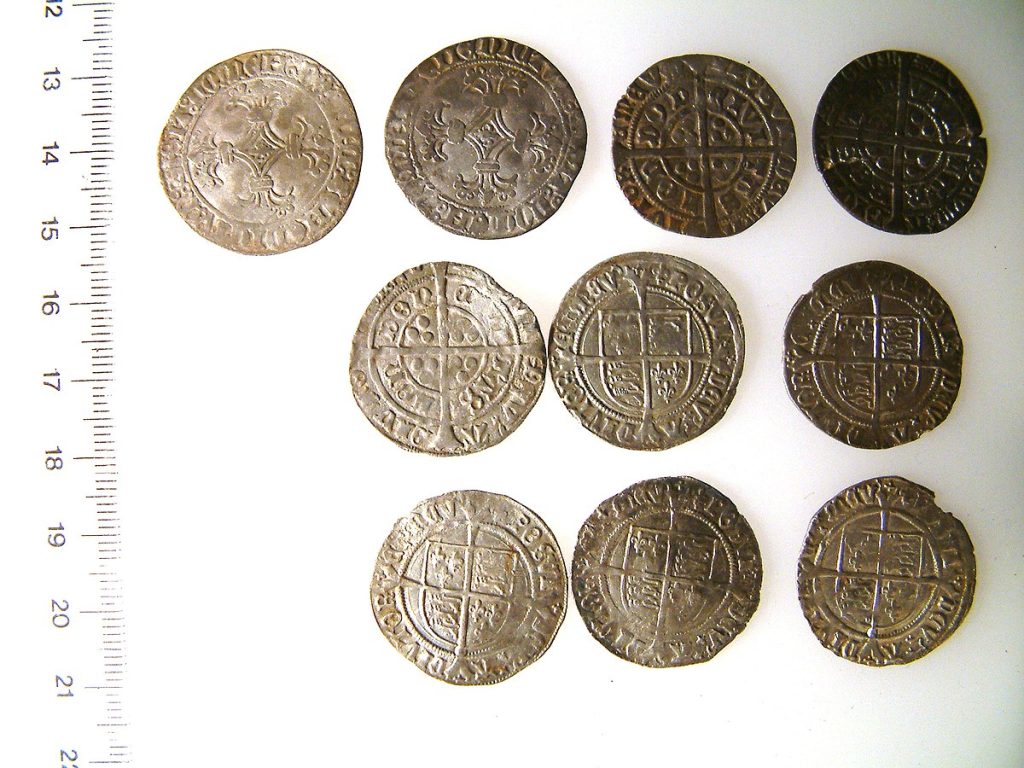 10 Early Post-Medieval silver groats, deposited after 1526 and before 1544 where the eaerlier coins had more silver than the later coins. Source: Wikimedia Commons
